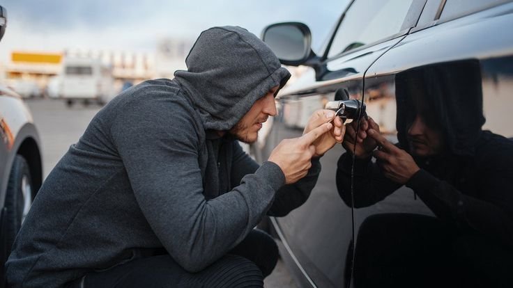 A man with a striker car